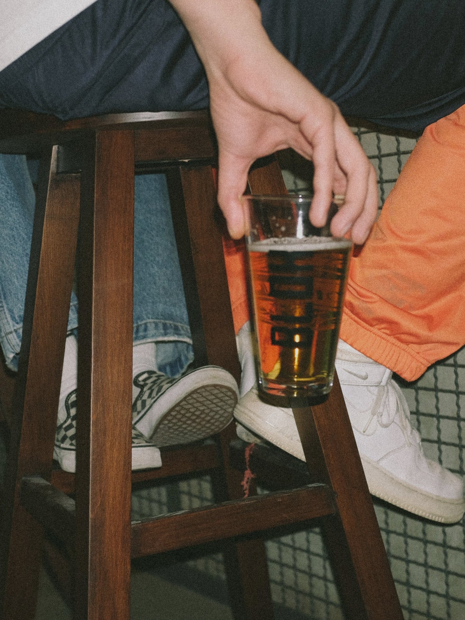 People sitting in a bar with beers in their hands